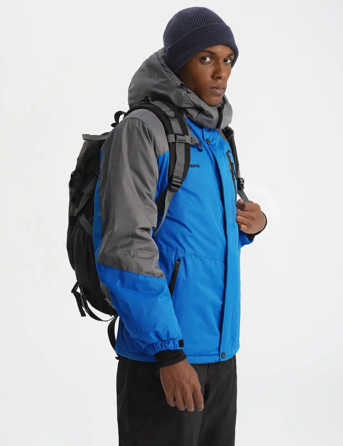 Person wearing a blue and gray outdoor jacket with a backpack.